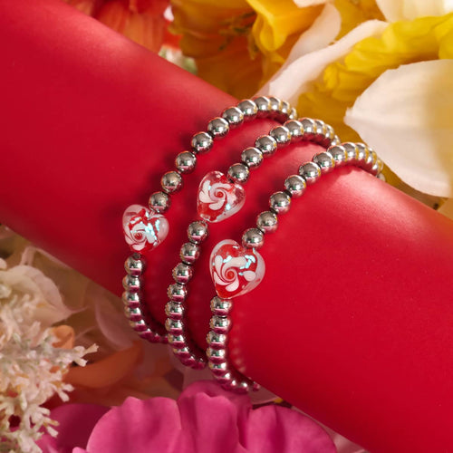 Crimson Swirl Glowing Heart Essence Bracelets with red and white heart beads on silver stainless steel beads wrapped around red holder by NOGU